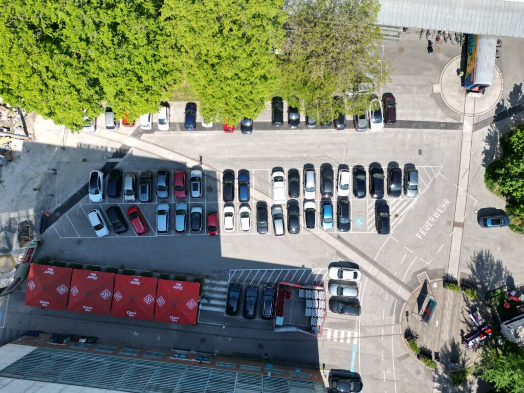 Blick aus der Vogelperspektive auf die Parkplätze vor dem Haus DAMES in der Tabakfabrik Linz, dieser Bereich soll umgestaltet werden (begrünter Innenhof)